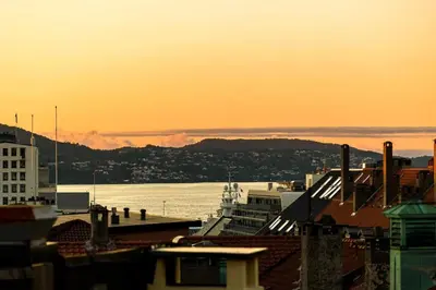 a view of a body of water at sunset at Torgalmenningen Town Square, Yet quiet, Elevator in building in Bergen