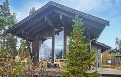 a small wooden house with a large window at Nice Home In Tinn Austbygd With Sauna in Luråsgrendi