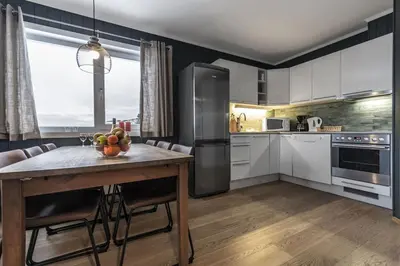 a kitchen with a table with a bowl of fruit on it at Ski in-Ski out and True Mountain Charm in Hemsedal