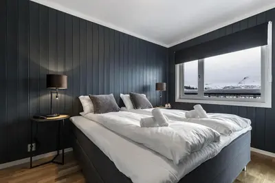 a large white bed in a room with a window at Ski in-Ski out and True Mountain Charm in Hemsedal