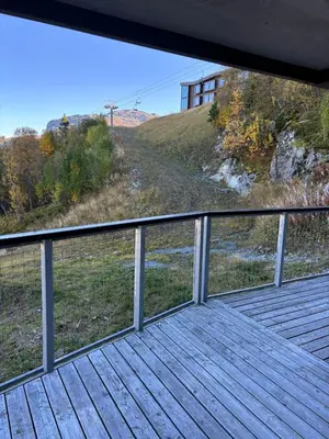 a wooden deck with a view of a hill at Family-Friendly Ski in-Ski out Retreat by Skarsnuten in Hemsedal