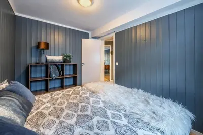 a living room with blue walls and a couch at Ski in-Ski out with Style and Scenic Views in Hemsedal