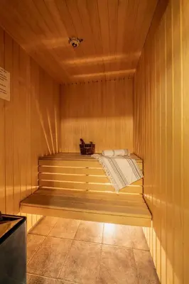 a sauna with a bench in a wooden wall at Ski in-Ski out and Perfect for Families in Hemsedal