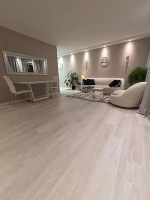 a living room with wooden floors and couches at Apartment, everything close in Hamar