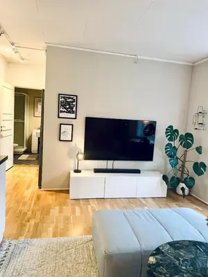 a living room with a large flat screen tv at Nice apartment super central at Solsiden in Trondheim