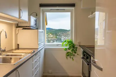a kitchen with a sink and a window at Small house close to nature and city in Bergen