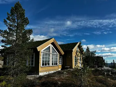 a small house on top of a hill at Mountain Cabin With Panoramic Views In Valdres in Etnedal