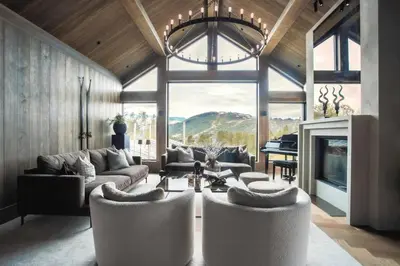 a living room with a couch and chairs and a piano at Modern Mountain Cabin With Views In Hovden in Hovden