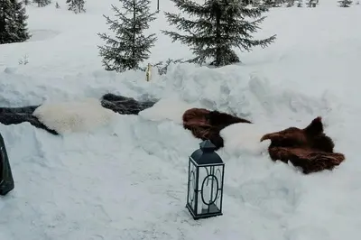 a lamp in the snow next to a pile of snow at Log Cabin By Mostertoppen Ski Stadium in Øyer