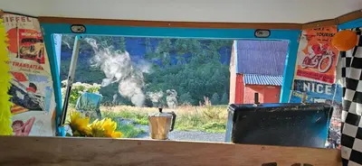 a window in a room with a tv and a view at Retro & Vintage Camping in Vaksdal
