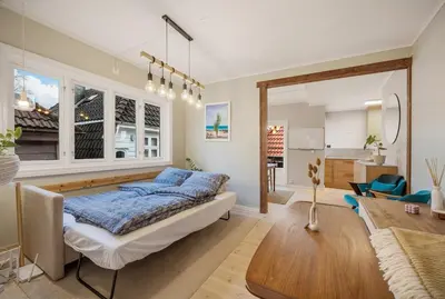 a bedroom with a bed and a living room at THIS IS BERGEN, 2 min walk to everything in Bergen