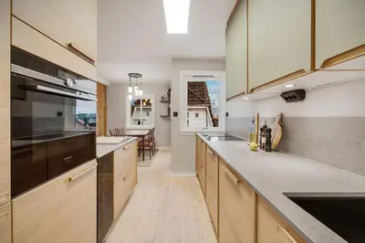 a kitchen with wooden cabinets and a counter top at THIS IS BERGEN, 2 min walk to everything in Bergen
