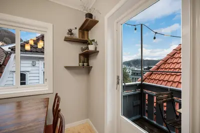 a room with a window and a balcony with a view at THIS IS BERGEN, 2 min walk to everything in Bergen