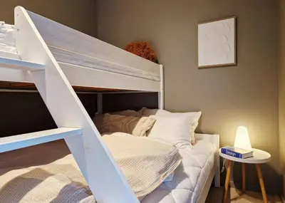 a bedroom with a bunk bed with a ladder at Brand New & High-End 3 Bedrooms 2 Bathrooms Central Apartment in Bergen