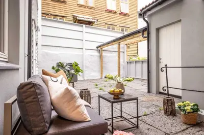 an outdoor patio with a couch and a table at Brand New & High-End 3 Bedrooms 2 Bathrooms Central Apartment in Bergen