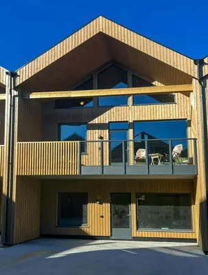 a building with two animals sitting on a balcony at Modern Apartment In The Heart Of Hovden in Hovden
