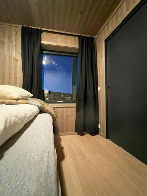 a bedroom with a bed and a window with at Modern Apartment In The Heart Of Hovden in Hovden
