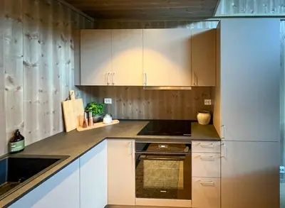 a kitchen with white cabinets and a stove at Modern Apartment In The Heart Of Hovden in Hovden