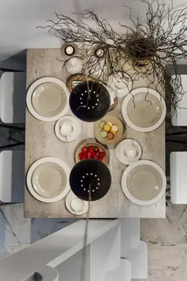 a table with white plates and fruit on it at Lysthuset den lille villa - authentic wodden house in Bergen