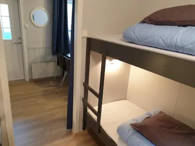two bunk beds in a room with a hallway at Tvinde Camping in Skulestadmo