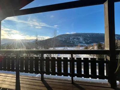 a view from the balcony of a house with snow covered mountains at Hafjell Ski-in Ski-Out in Øyer