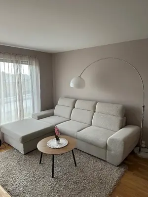 a living room with a couch and a table at Apartament Near Haugesund in Skred