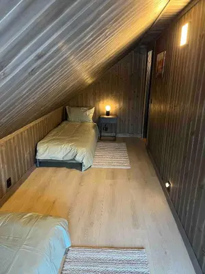 a room with two beds in a wooden cabin at Nice cabin at Norefjell skicenter in Noresund