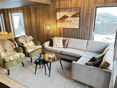 a living room with a couch and chairs and a table at Nice cabin at Norefjell skicenter in Noresund