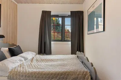 a bedroom with a bed in front of a window at Trysilfjell 752E by Vacation Trysil in Trysil