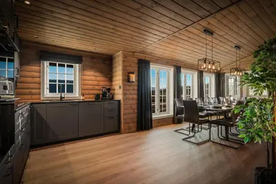 a kitchen and dining room with a dining table at The Nordic Retreat - Stryn in Stryn