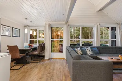 a living room with a couch and a table at Alpingrenda 38B by Vacation Trysil in Trysil
