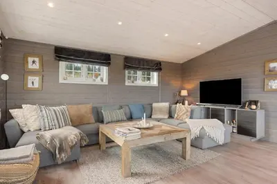 a living room with a couch and a tv at Mosetra2038 by Vacationtrysil in Trysil
