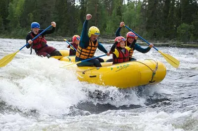 a group of people in a raft on a river at Fjellvangvegen 11 by Vacation Trysil in Trysil