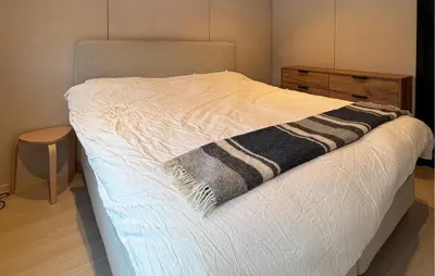 a bed with a black and white blanket on it at Beautiful Home In Bjorli in Bjorli