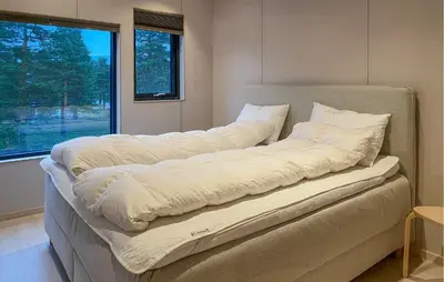 a large bed in a room with a window at Beautiful Home In Bjorli in Bjorli