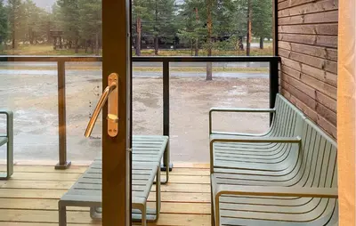 two chairs sitting on a porch with a view of water at Beautiful Home In Bjorli in Bjorli