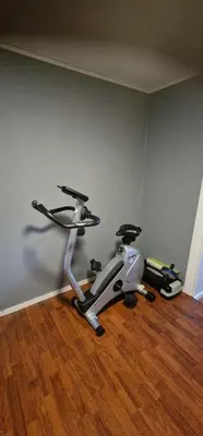 a exercise bike in a room with a wooden floor at Comfortable apartment near the city center and nature