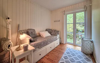 a bed in a room with a large window at Beach Front Home In Vaksdal With House Sea View in Vaksdal