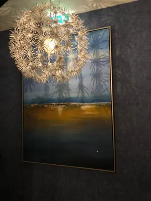 a chandelier hanging over a picture of the ocean at Vestnes Fjordhotell in Vestnes