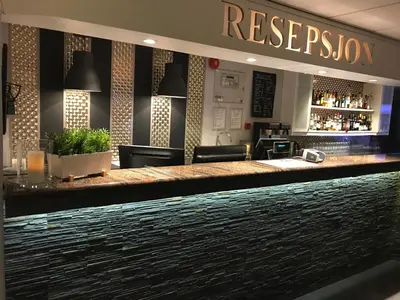 a bar in a restaurant with a reception at Vestnes Fjordhotell in Vestnes