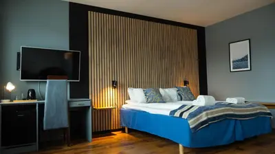 a bedroom with a bed and a flat screen tv at Vestnes Fjordhotell in Vestnes