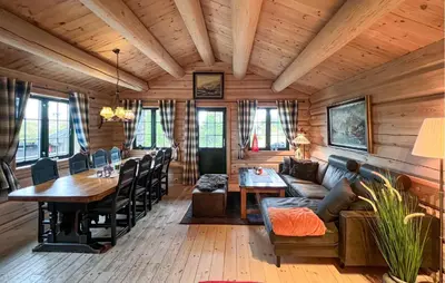 a living room with a table and a couch at Lovely Home In Sjusjøen With Sauna in Sjusjøen