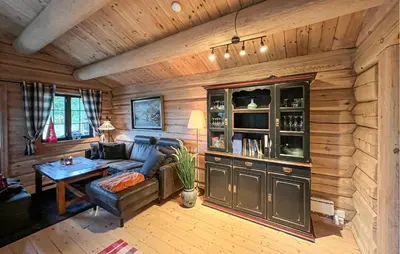 a living room with a blue couch and a table at Lovely Home In Sjusjøen With Sauna in Sjusjøen