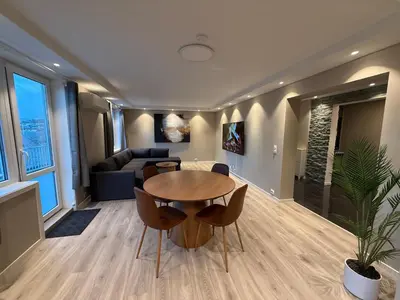 a living room with a table and a couch at Kristiansund Luxury Apartment in Kristiansund