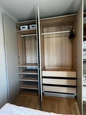a walk in closet with wooden cabinets and shelves at Newly refurbished apartment in the city center in Verdal