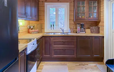 a kitchen with wooden cabinets and a sink and a window at Gorgeous Home In Bjorli With Wifi in Bjorli