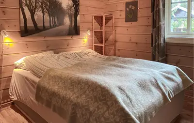 a bedroom with a bed with a blanket on it at Gorgeous Home In Bjorli With Wifi in Bjorli