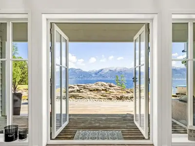 an open door with a view of the ocean at Holiday Home Holmen by Interhome in Strandebarm