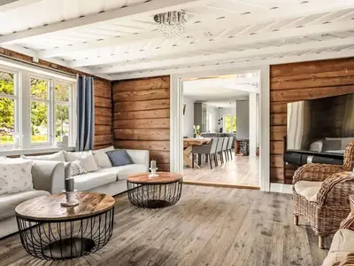 a living room with a couch and a table at Holiday Home Holmen by Interhome in Strandebarm