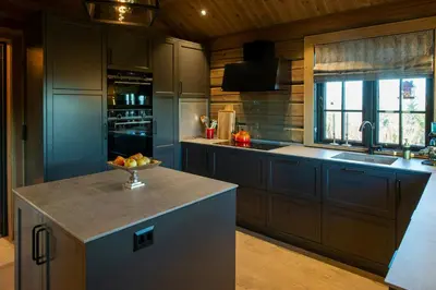 a kitchen with a bowl of fruit on a counter at Handcrafted Log Cabin At Golsfjellet in Gol